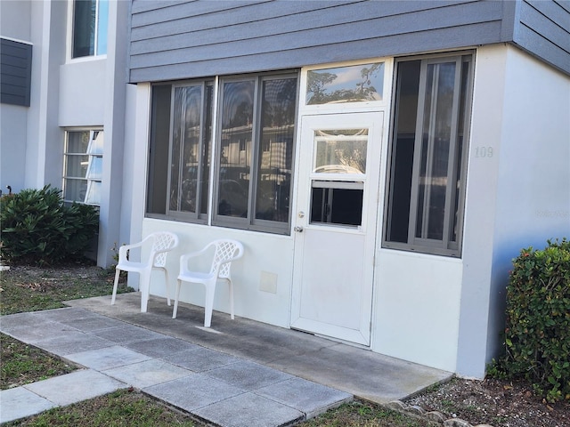 entrance to property with a patio