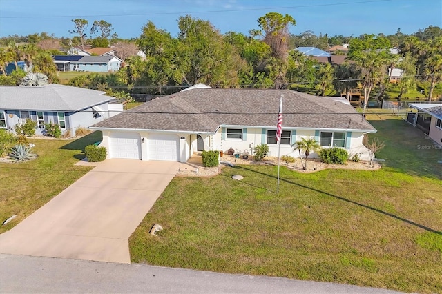 view of front of home with a garage and a front lawn