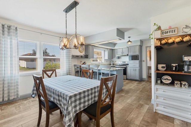 dining room featuring a notable chandelier and light hardwood / wood-style flooring