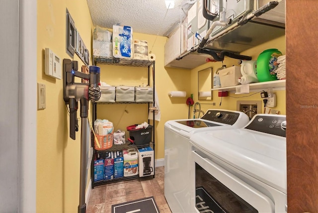 laundry room featuring independent washer and dryer, dark hardwood / wood-style floors, and a textured ceiling