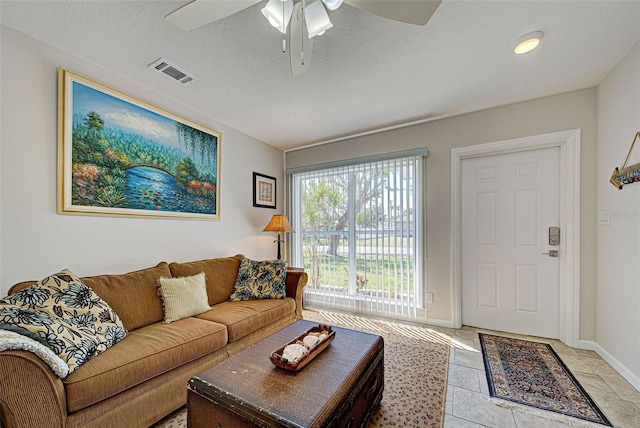 tiled living room with ceiling fan