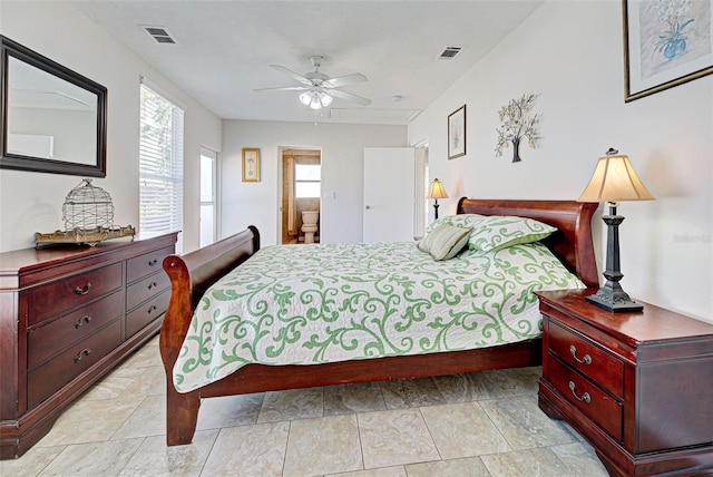 bedroom with multiple windows, connected bathroom, and ceiling fan