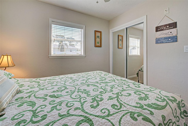 bedroom with ceiling fan and a closet