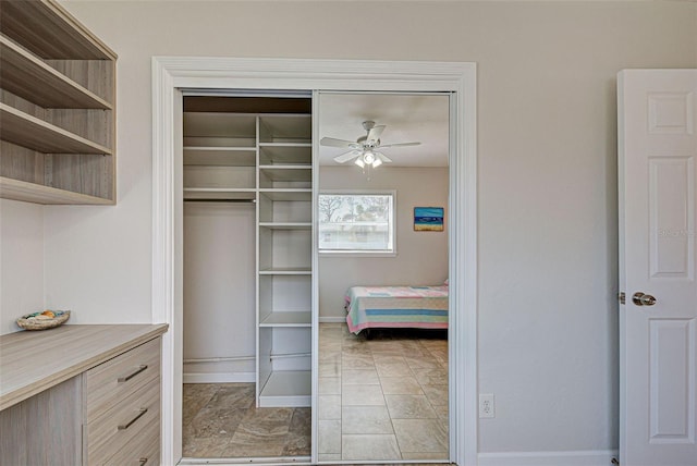 bedroom with ceiling fan and a closet