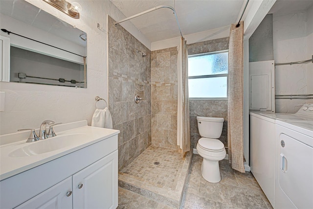 bathroom featuring vanity, separate washer and dryer, curtained shower, and toilet