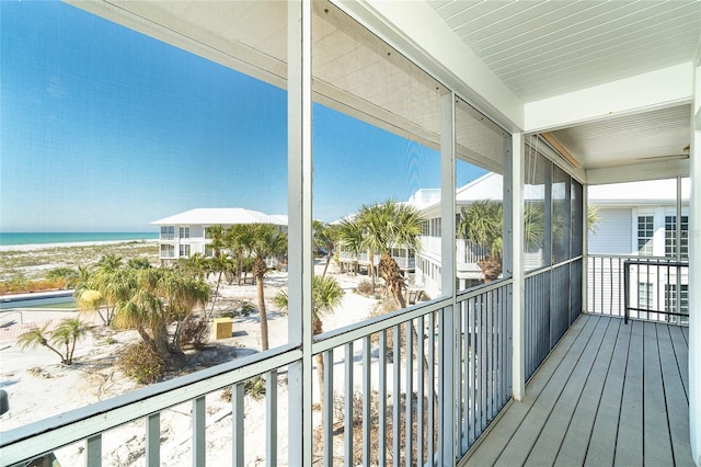 balcony featuring a water view and a view of the beach