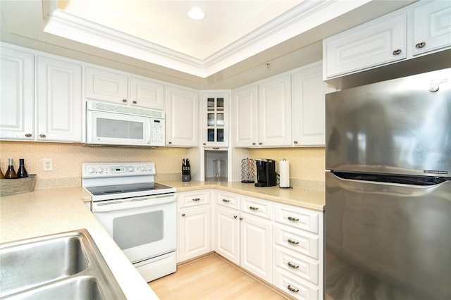 kitchen featuring white cabinetry, white appliances, ornamental molding, and sink