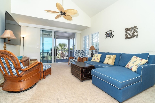 carpeted living room with high vaulted ceiling and ceiling fan