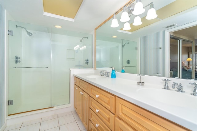 bathroom featuring tile patterned flooring, vanity, and walk in shower