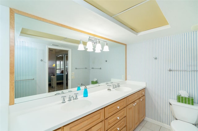 bathroom with vanity, toilet, and tile patterned flooring