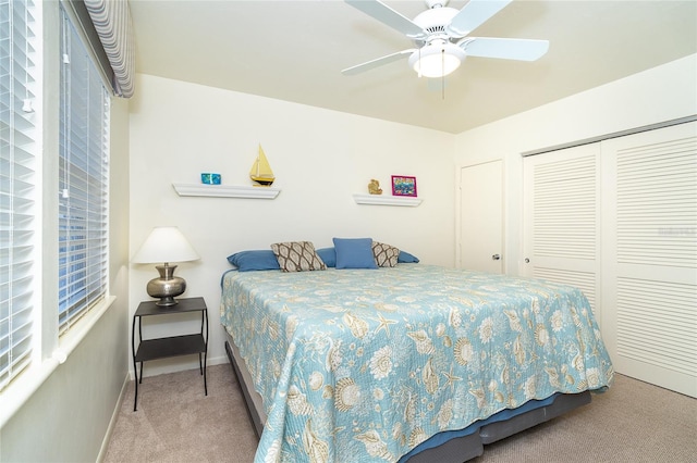 carpeted bedroom featuring a closet and ceiling fan