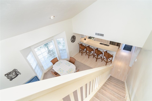 staircase with high vaulted ceiling