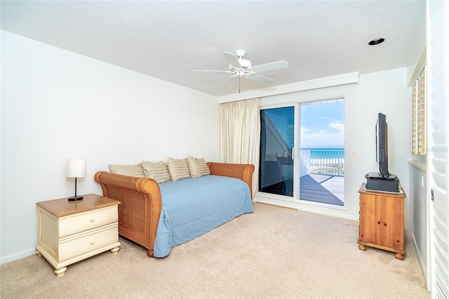 bedroom featuring ceiling fan, light carpet, and access to outside