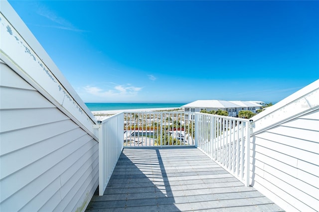 deck featuring a water view and a beach view