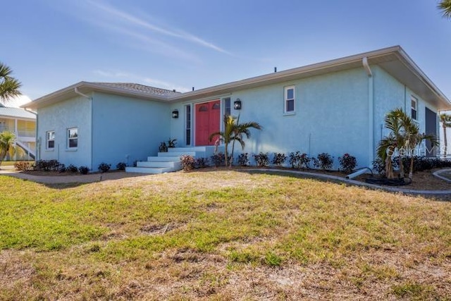 ranch-style home with a front lawn