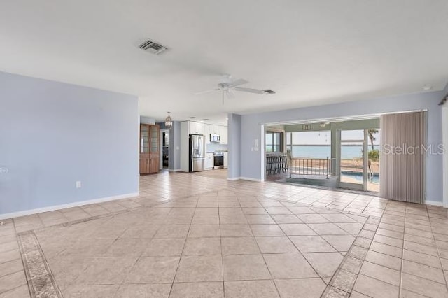 unfurnished living room with ceiling fan and light tile patterned flooring