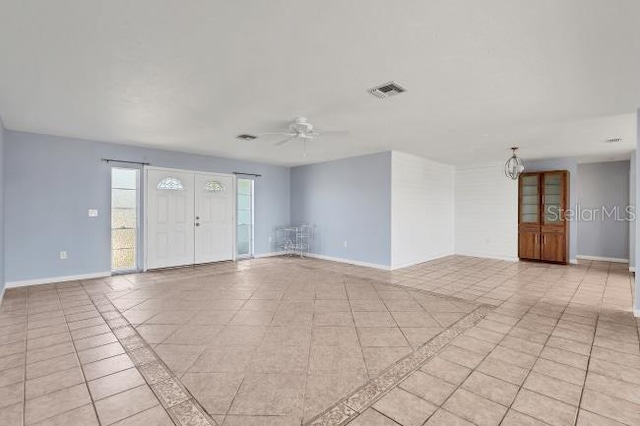 tiled empty room with ceiling fan