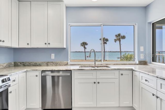 kitchen with dishwasher, sink, white cabinets, a water view, and light stone countertops