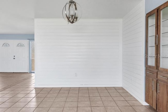 unfurnished dining area with light tile patterned flooring