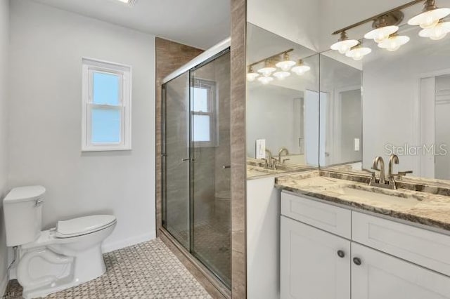 bathroom with walk in shower, vanity, and toilet