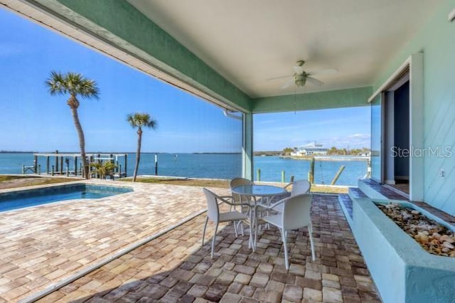 view of patio with ceiling fan and a water view