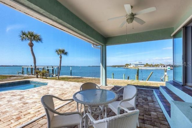 view of patio / terrace featuring a water view and ceiling fan