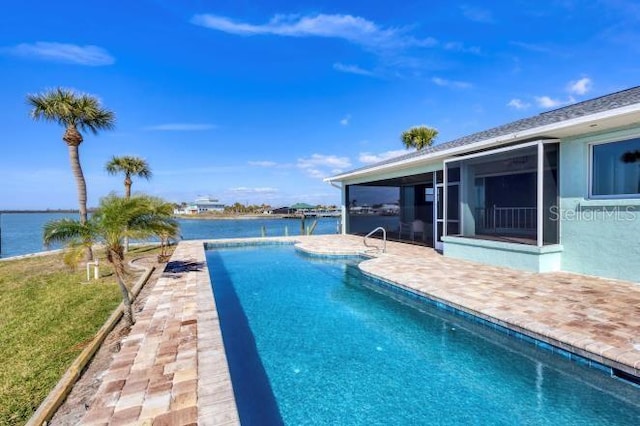 view of swimming pool with a water view, a yard, and a patio area