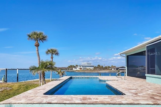 view of swimming pool featuring a patio area, a sunroom, and a water view