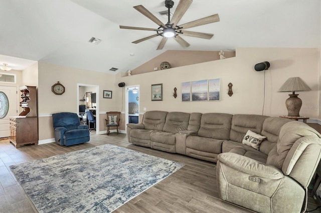 living room with hardwood / wood-style floors, vaulted ceiling, and ceiling fan