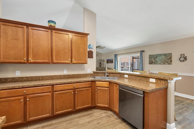 kitchen with lofted ceiling, sink, stainless steel dishwasher, kitchen peninsula, and light wood-type flooring