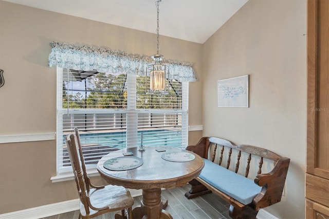 dining area featuring hardwood / wood-style flooring and lofted ceiling