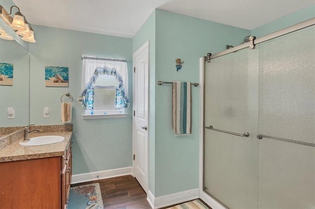 bathroom with a shower with door and vanity