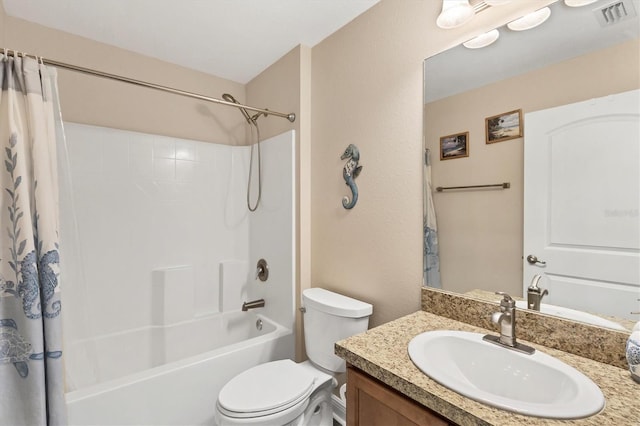 full bathroom with vanity, shower / tub combo, and toilet