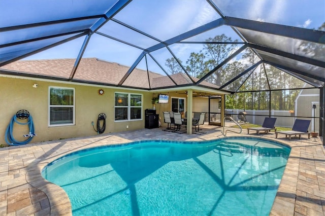 view of swimming pool with a lanai and a patio