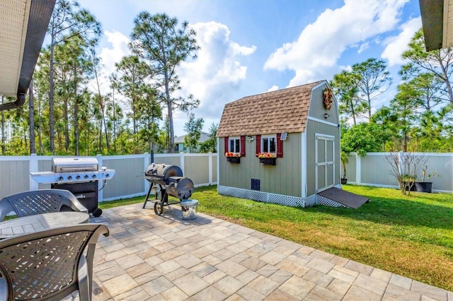 view of patio featuring area for grilling and a storage unit