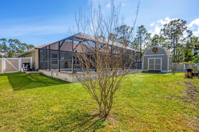 view of yard featuring a fenced in pool, a lanai, and a storage shed