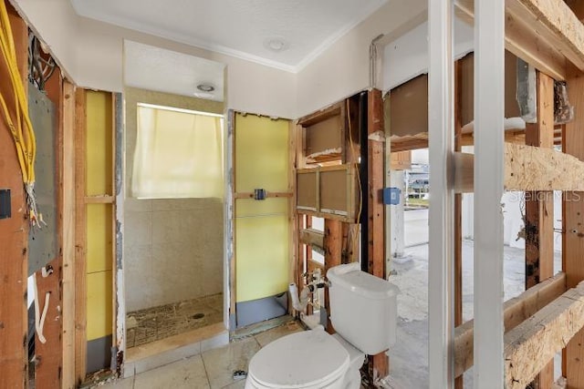 bathroom featuring crown molding and toilet