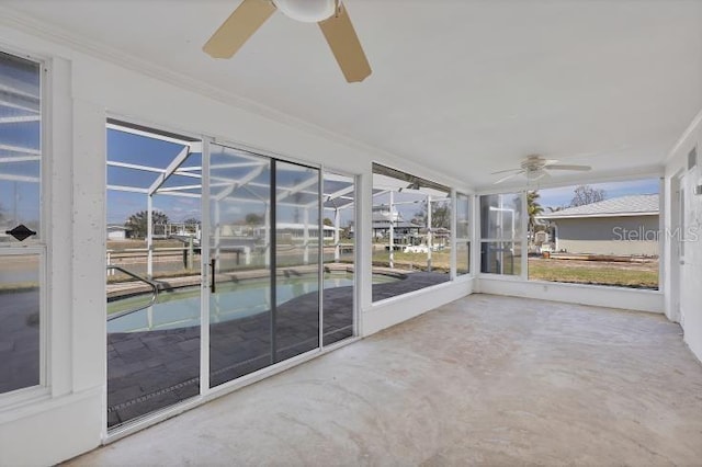 unfurnished sunroom featuring ceiling fan