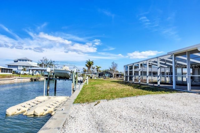 view of dock featuring a water view, a yard, and a lanai