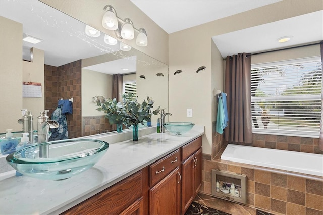 bathroom featuring vanity, tiled bath, and tile patterned floors