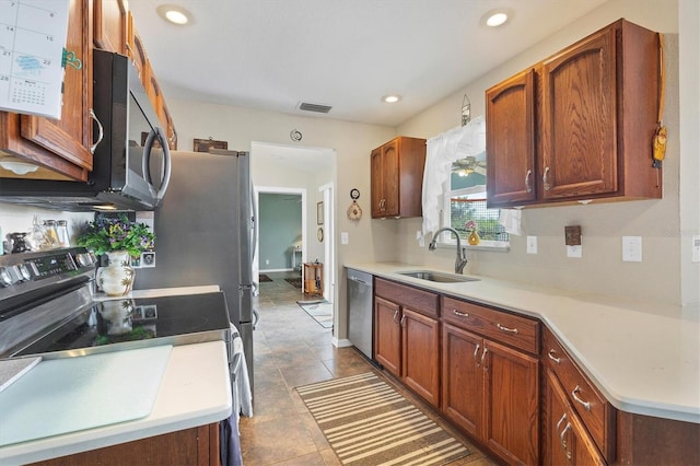 kitchen featuring sink, light tile patterned floors, and stainless steel appliances