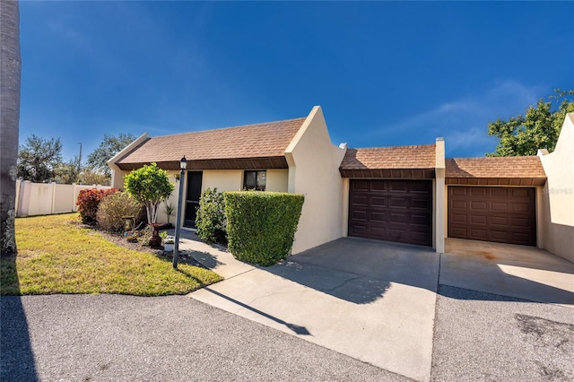 single story home featuring a garage and a front yard