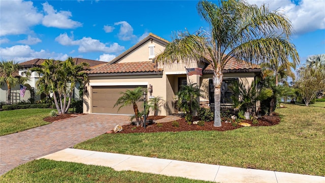 mediterranean / spanish house with a front lawn and a garage