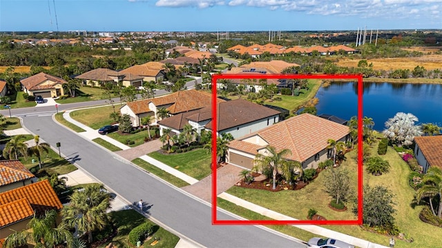 birds eye view of property with a water view