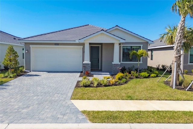 view of front of home with a garage and a front lawn