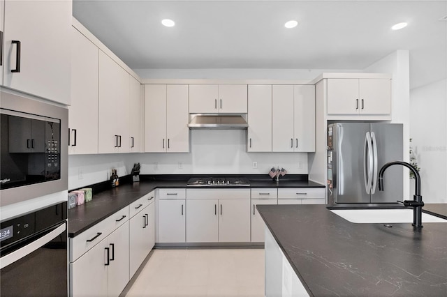 kitchen with sink, white cabinets, and black appliances