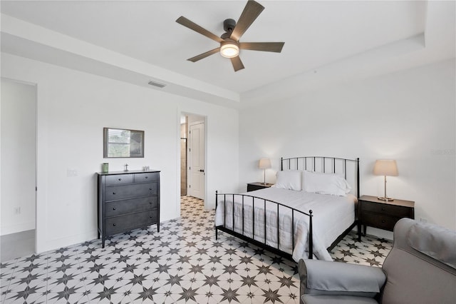 bedroom featuring ceiling fan and a raised ceiling