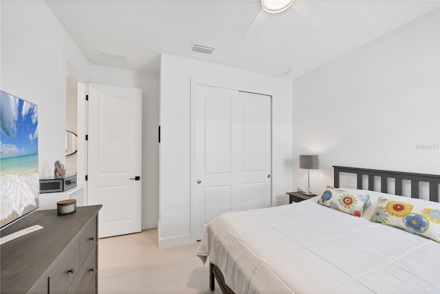 bedroom with ceiling fan and a closet