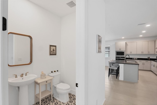 bathroom with sink and toilet