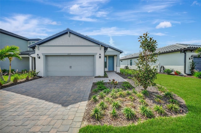 view of front of home with a front yard and a garage